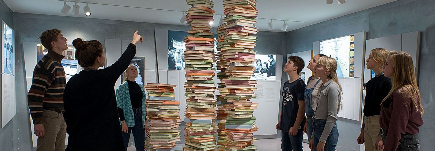 Stack of Documents with young people surrounding