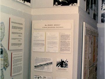 Auf dem Bild sieht man einige Ausstellungstafeln der Stasi über die Zeugen Jehovas. Darauf sind Zeitungsberichte und Dokumente zu sehen.